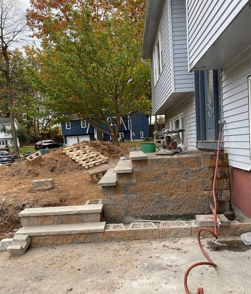A house with stairs being built on the side of it.