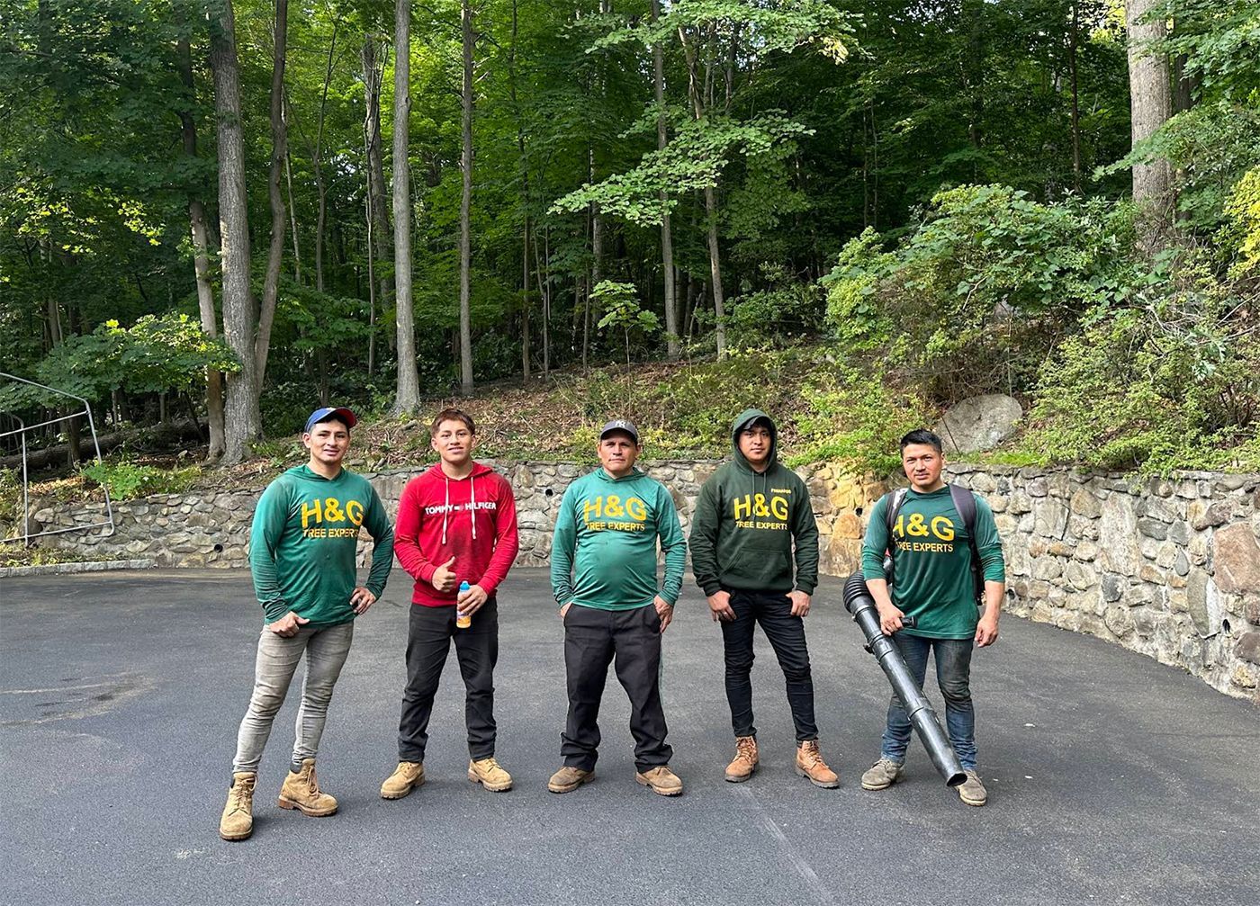 A group of men are standing next to each other in a parking lot.