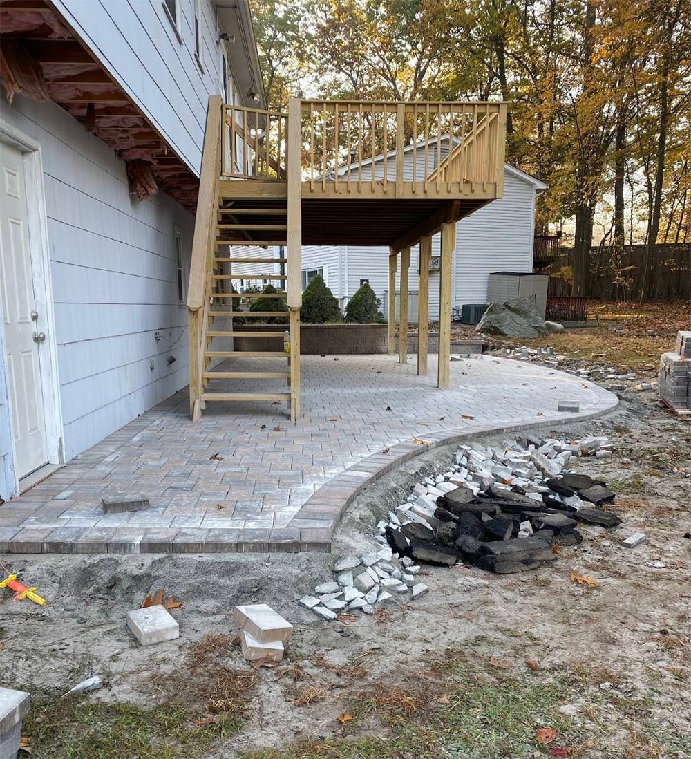 A house with a wooden deck and stairs on the side of it