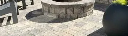 There is a fire pit in the middle of the patio.