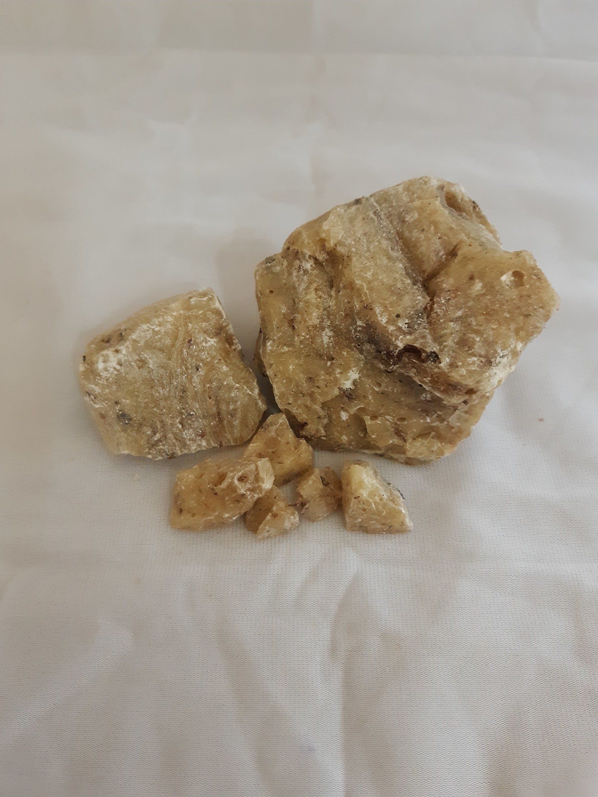 A large piece of rock is sitting on a white cloth.