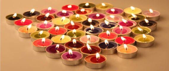 A bunch of colorful candles are sitting on a table.