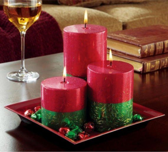 Three red and green candles on a tray on a table