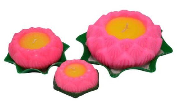 Three pink candles in the shape of lotus flowers