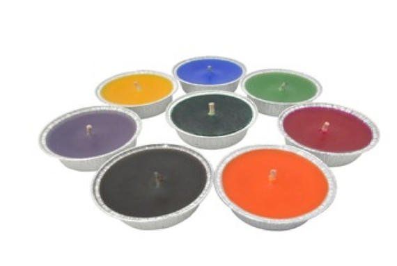 A group of candles of different colors are arranged in a circle