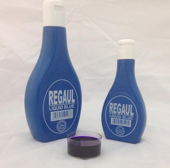Two bottles of regal liquid blue next to a cup of liquid blue