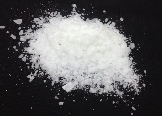 A pile of white powder on a black surface.