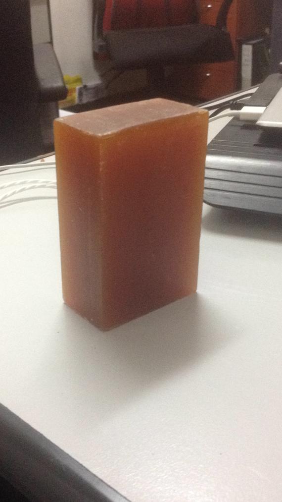 A brown block of soap is sitting on a white table.