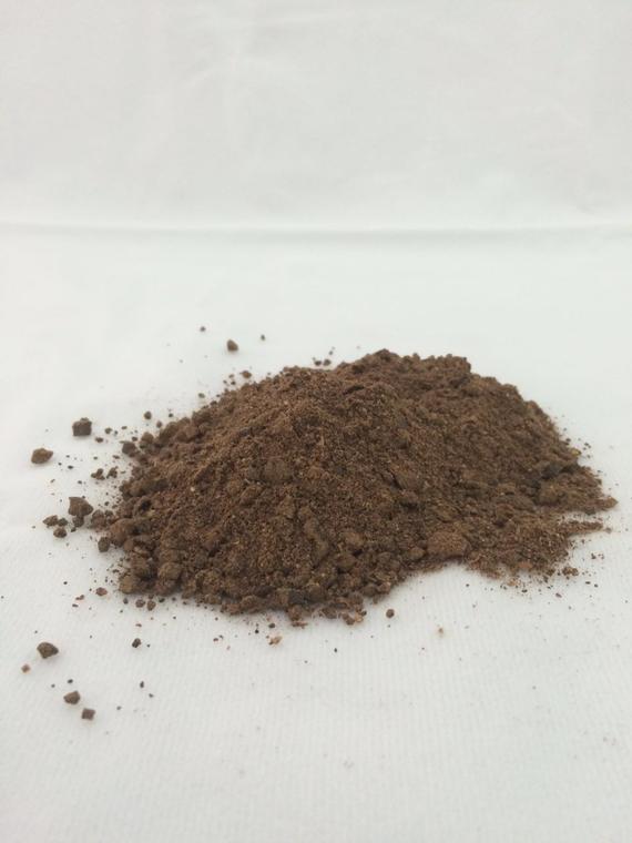 A pile of brown powder on a white surface