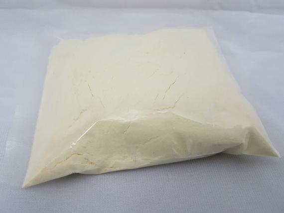 A bag of white powder is sitting on a white surface.