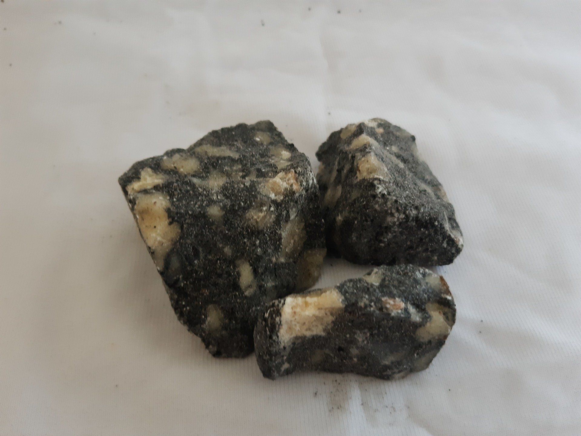 A pile of rocks are sitting on a white surface