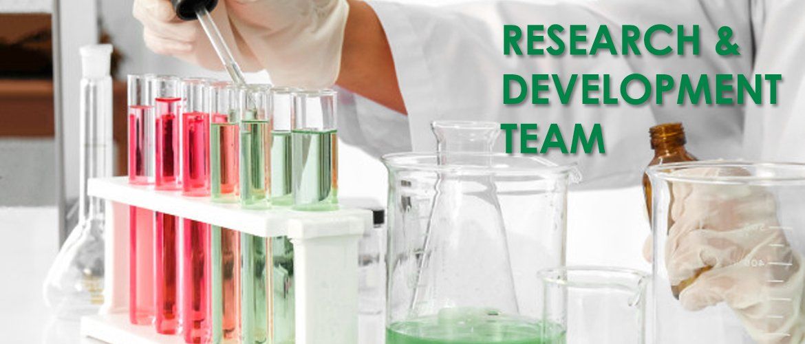 A person is pouring liquid into test tubes in a laboratory.