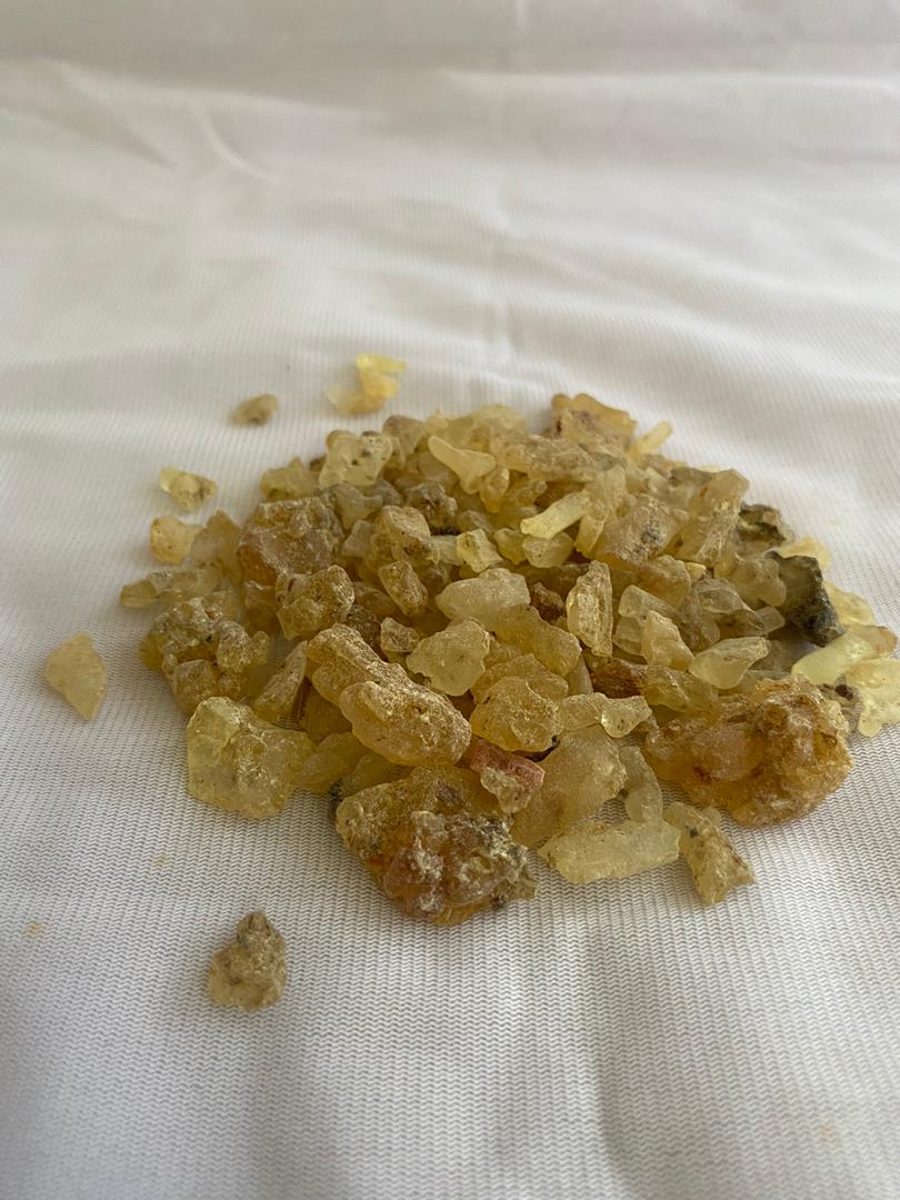 A pile of food is sitting on a white cloth on a table.