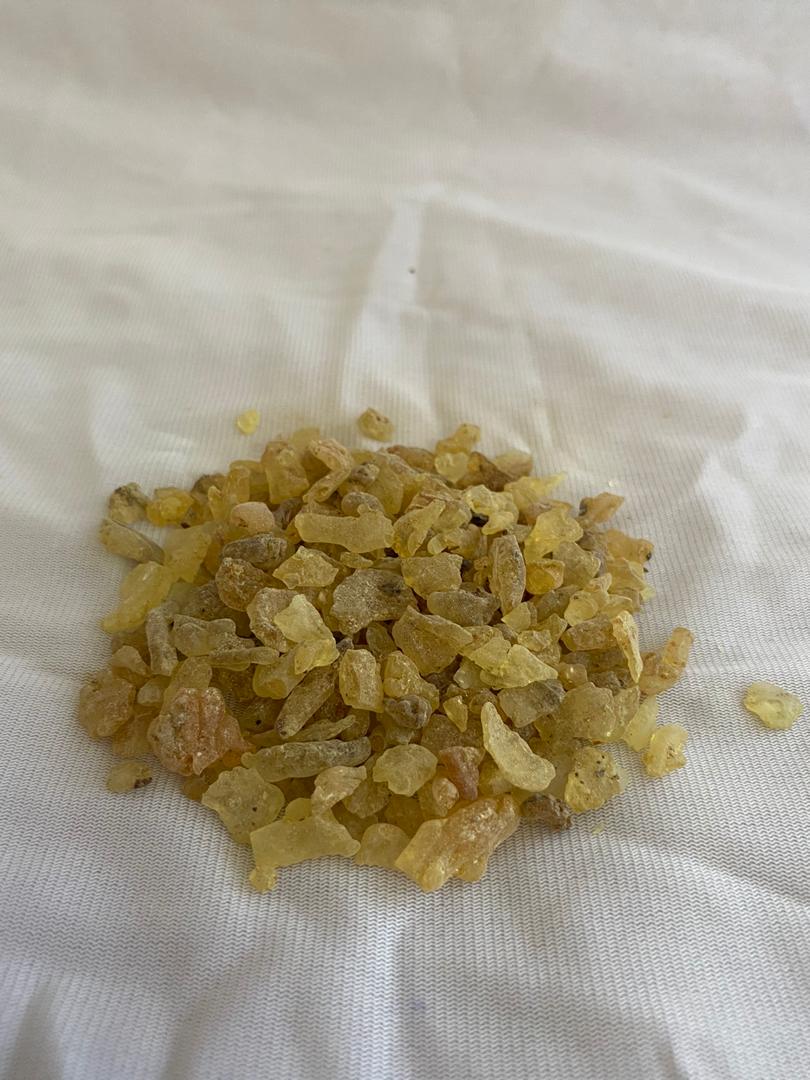 A pile of raisins is sitting on top of a white cloth.