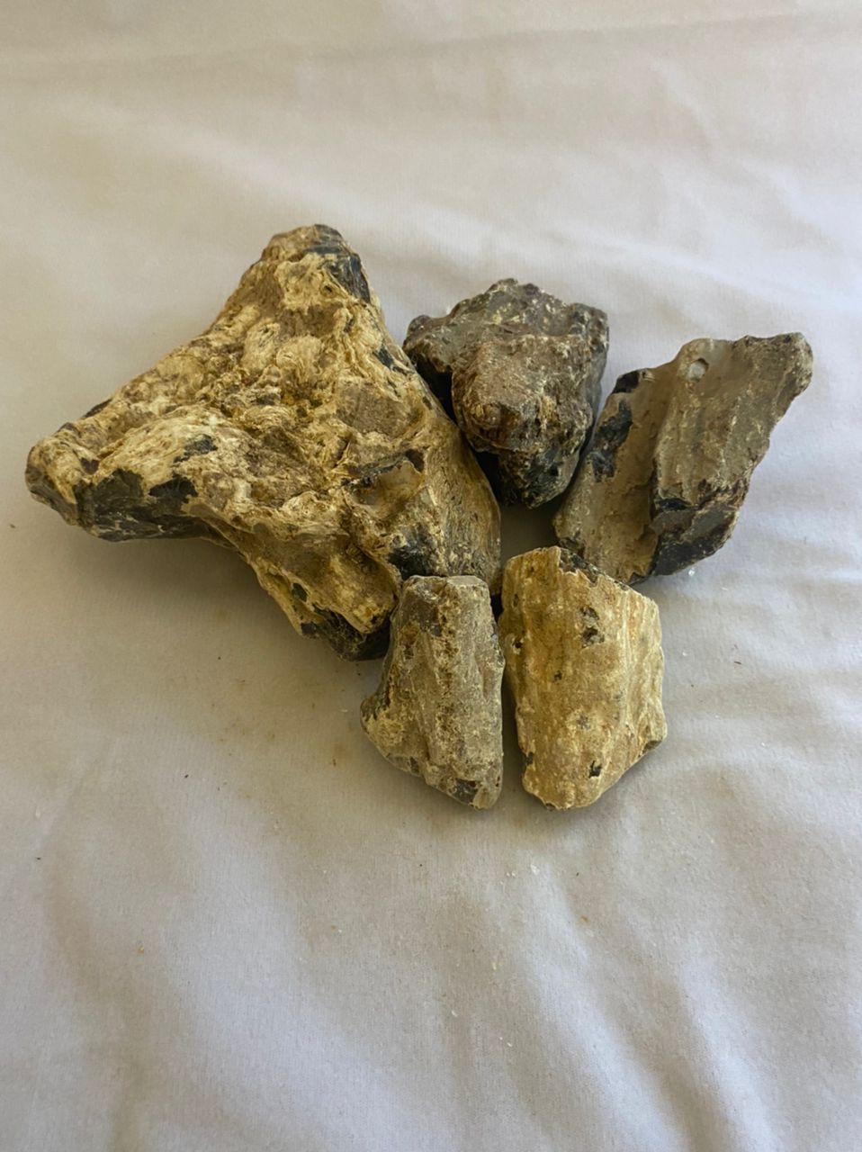 A pile of rocks sitting on top of a white surface.