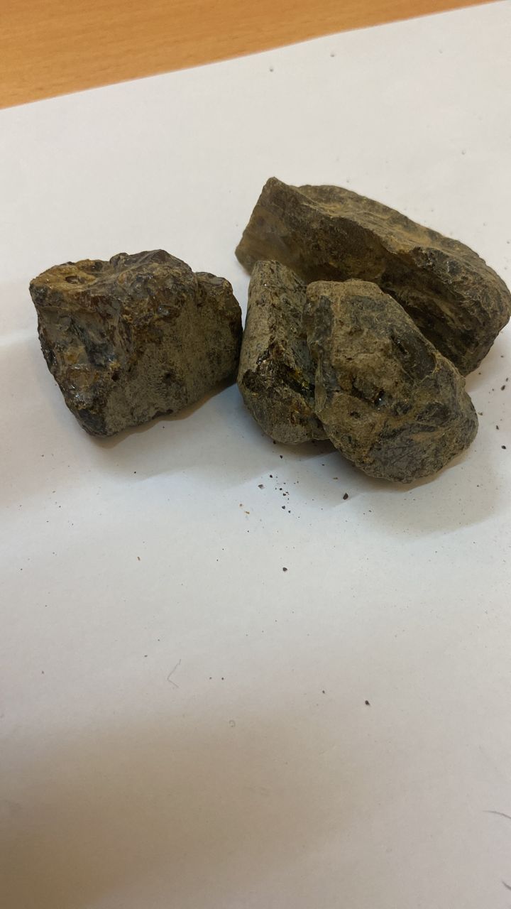 A pile of rocks sitting on top of a white surface.