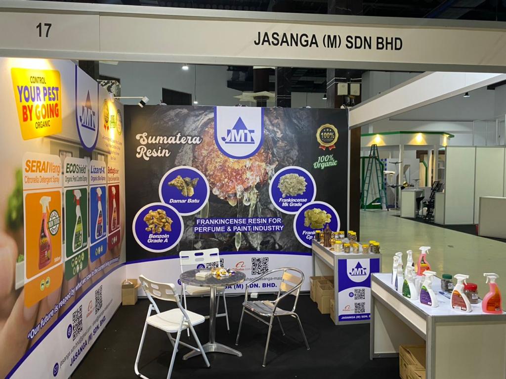 A booth at a convention with a table and chairs.