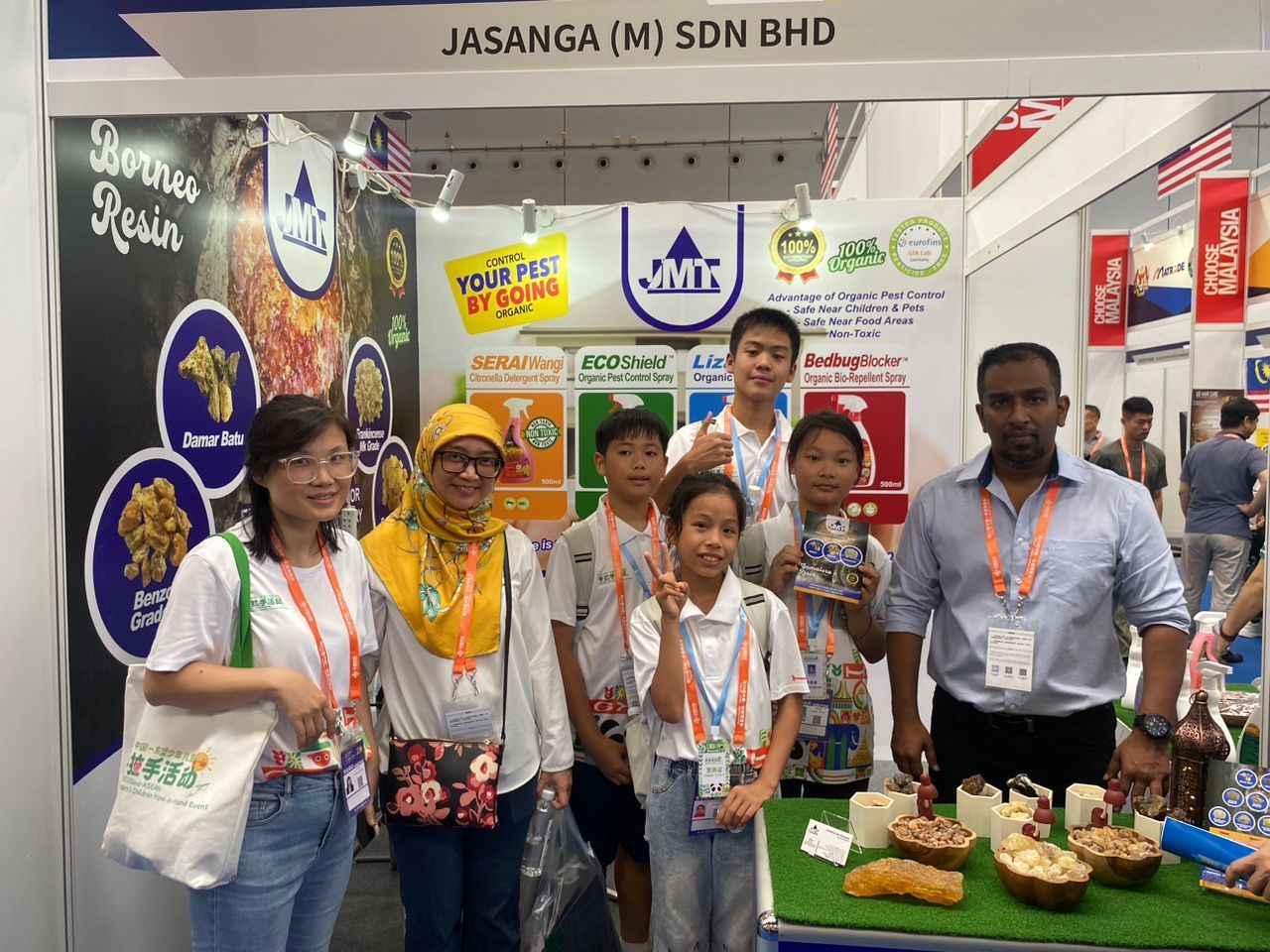 A group of people are posing for a picture in front of a booth.