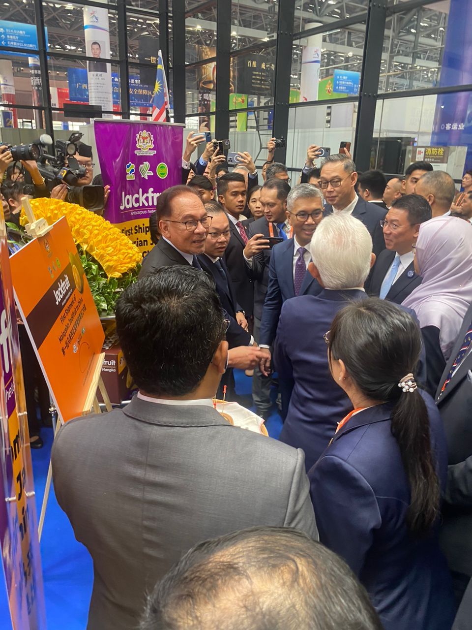 A group of people are standing in front of a sign that says jockey