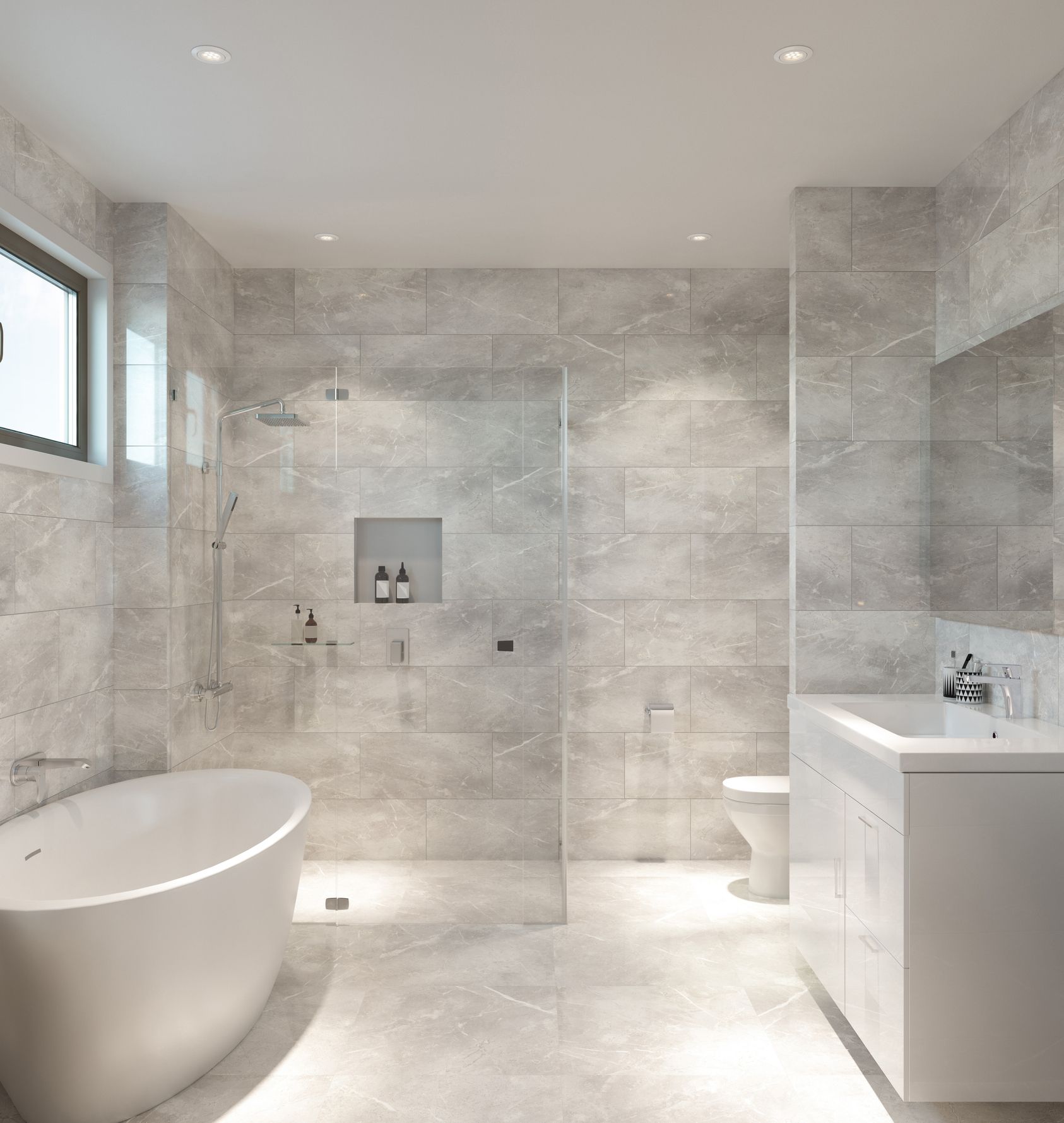 Modern bathroom with gray tile walls and floor, white tub and sink, and a glass shower.
