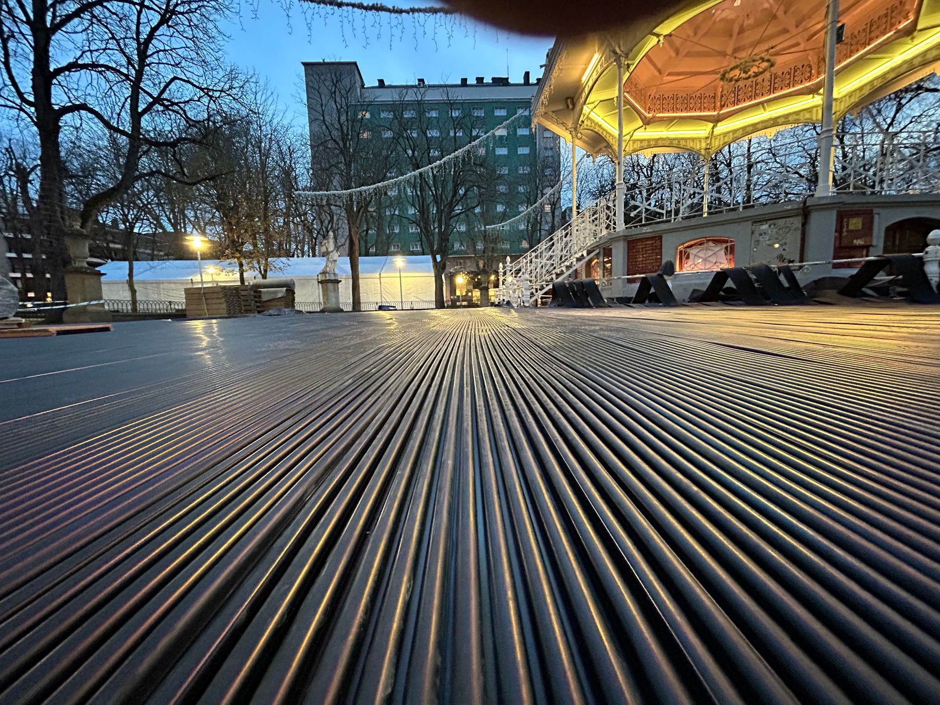 Una persona está tomando una fotografía de un mirador en un parque por la noche.