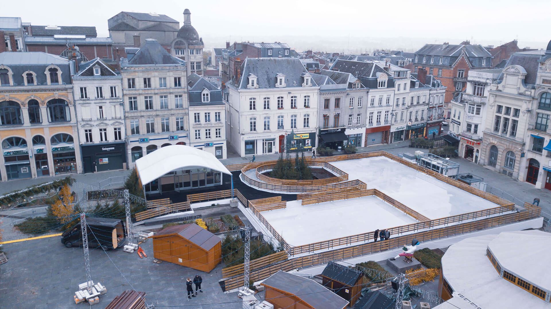 Pista de hielo en centro urbano con division por medio de valla de madera