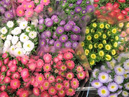 Un mazzo di fiori di diversi colori è appoggiato su un tavolo.