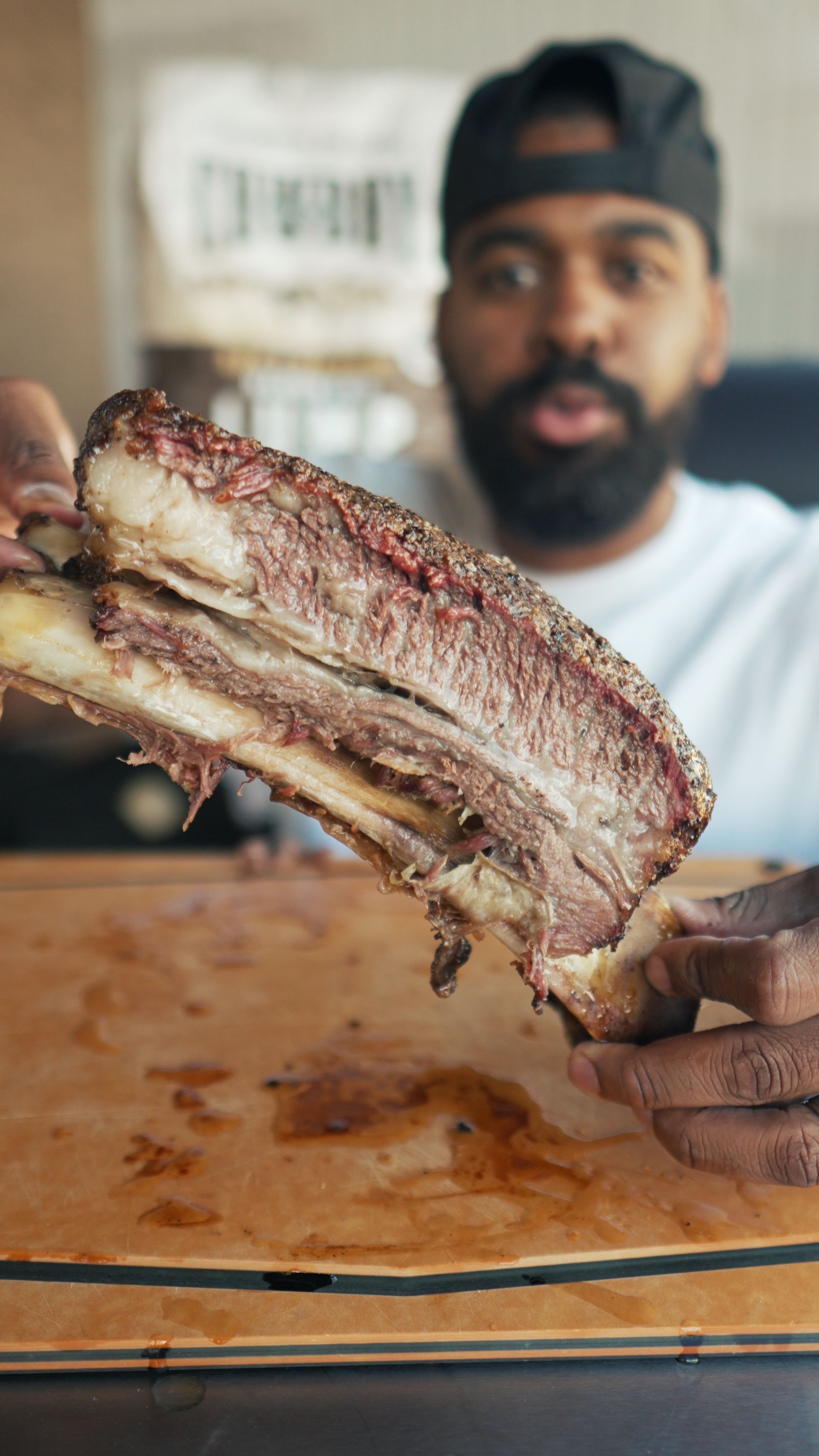 Man holding beef dino rib 