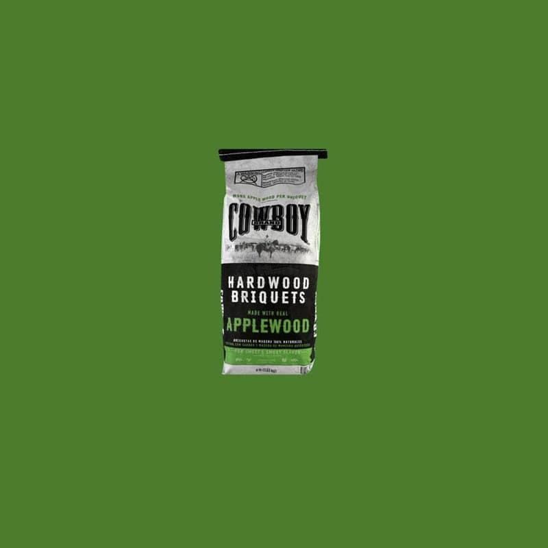 Bag of Cowboy hardwood briquets with applewood on a green background.