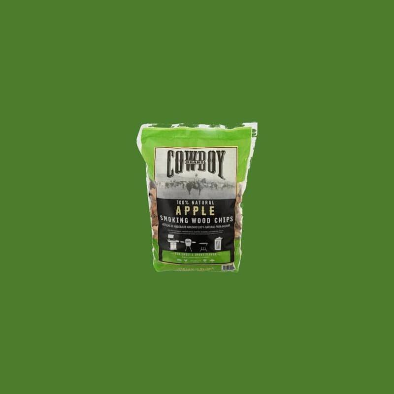 A bag of cowboy apple wood chips for smoking on a green background