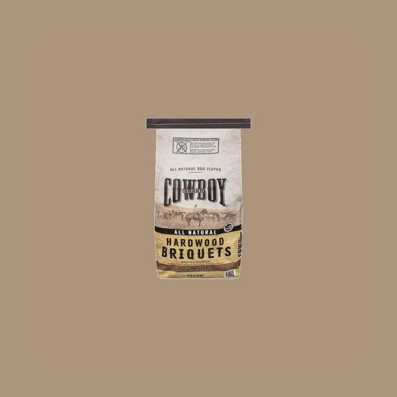 A bag of cowboy hardwood briquets on a brown background.