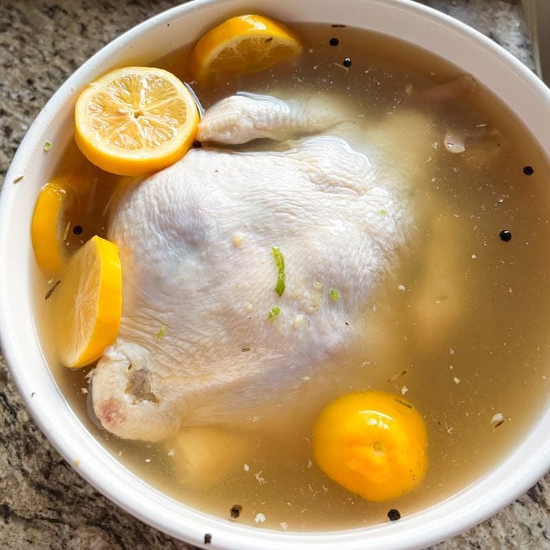 A whole chick in a brine with some lemons