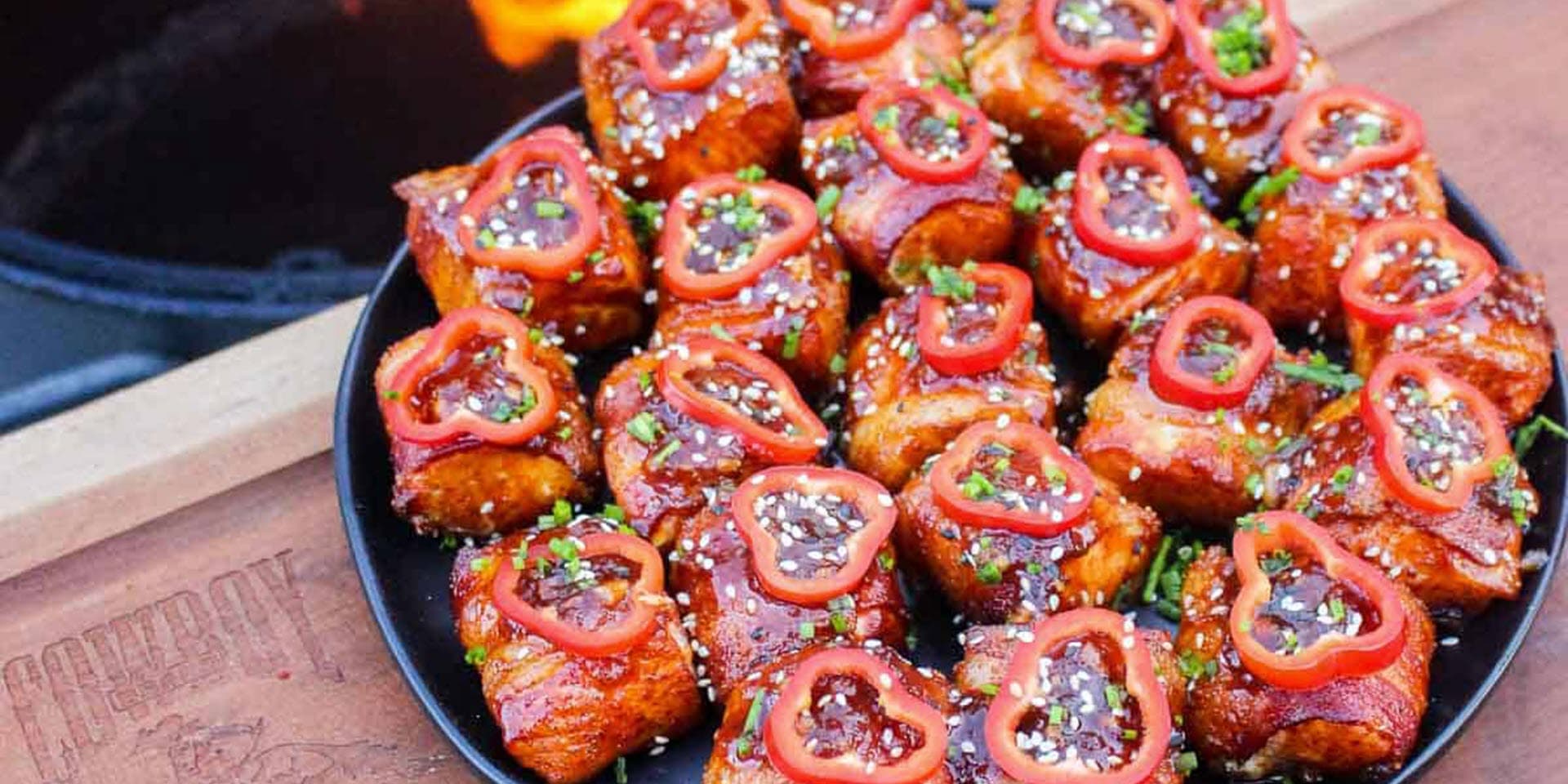 Bacon-wrapped salmon bites garnished with peppers
