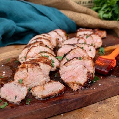 BBQ Pork Tenderloin sliced on a cutting board
