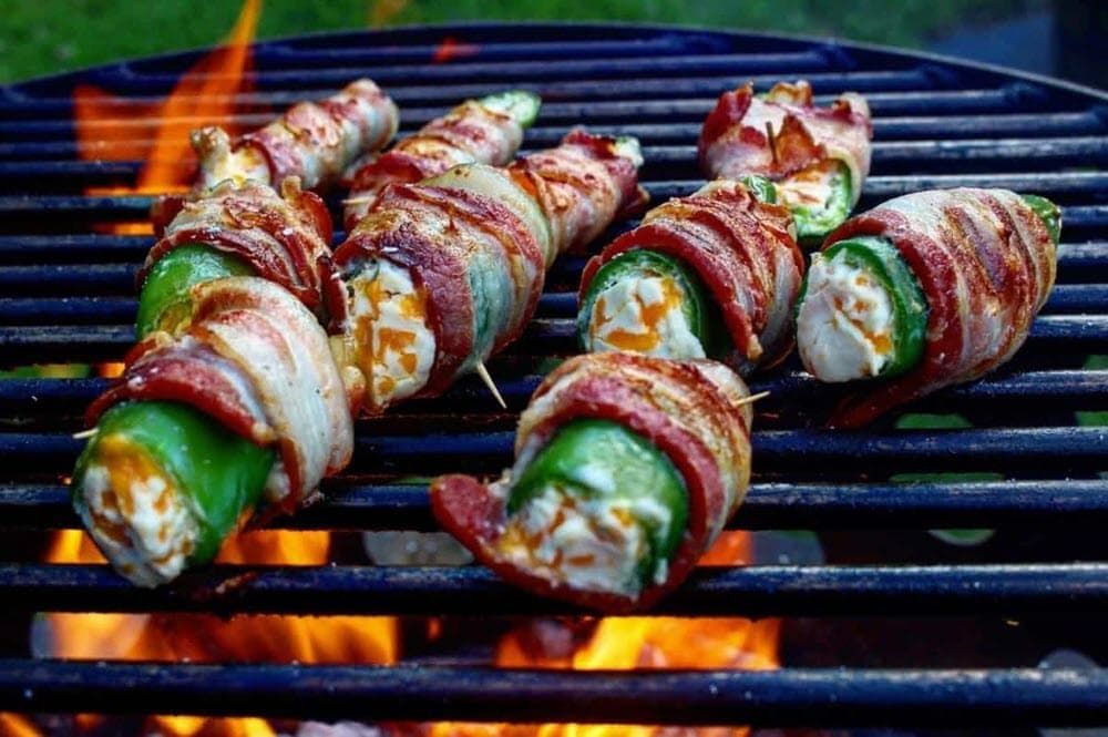 bacon wrapped jalapeno poppers cooking over live fire