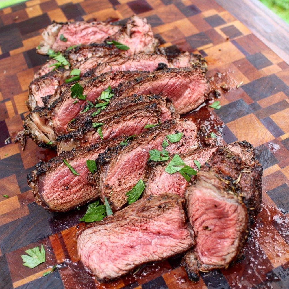 sliced Bison ribeye steak on a cutting board