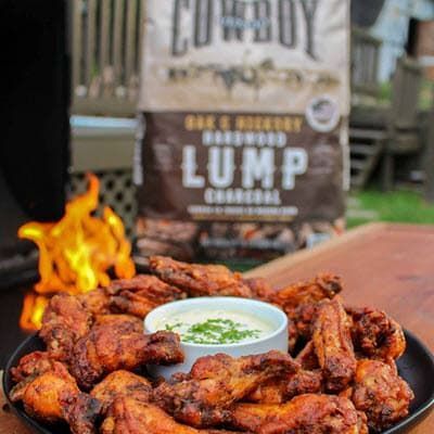 Double Fried Chicken Wings with dip and bag of Cowboy Oak & Hickory Lump in background