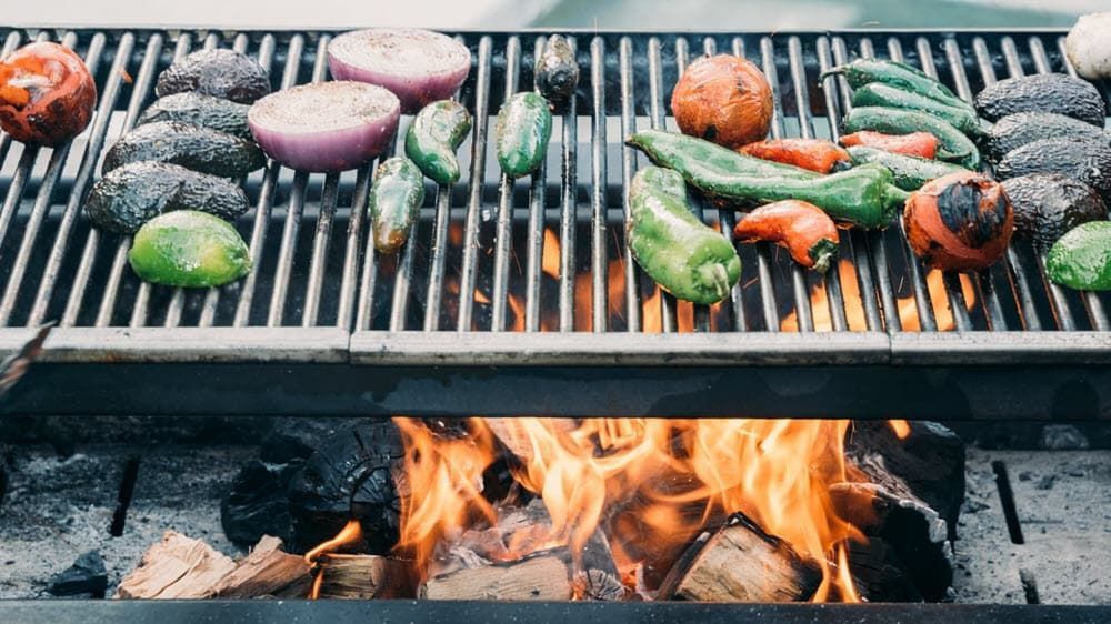 Tomatoes, peppers, onions & avocados grilling over live fire