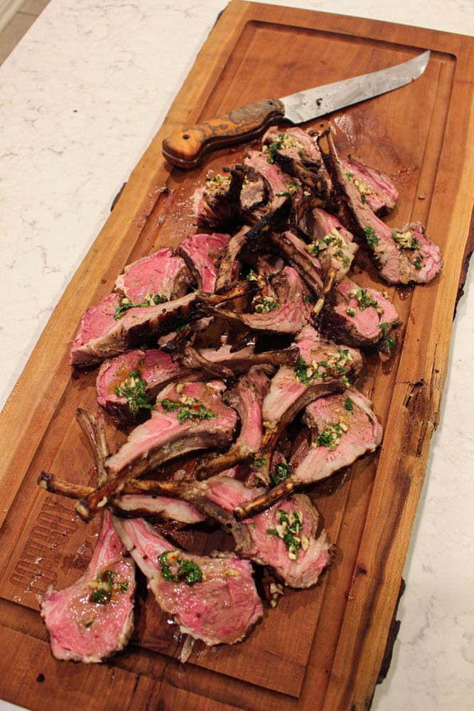 Grilled Lamb chops with mint chimichurri on cutting board