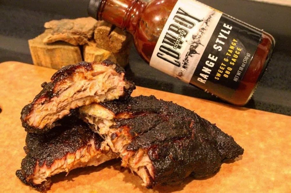 BBQ maple bourbon ribs with bottle of Cowboy Range Style BBQ sauce