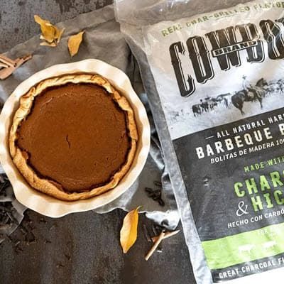 whole smoked pumpkin pie with bag of Cowboy Charcoal & Apple Pellets