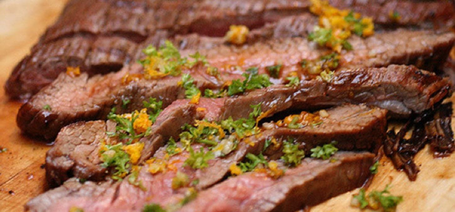 sliced flank steak garnished with parsley