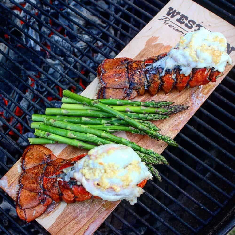 lobster tails and asparagus on cedar plank on the grill