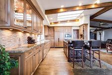 Picture of a renovated rustic home, the kitchen is newly remodeled with new cabinets, lighting and flooring.