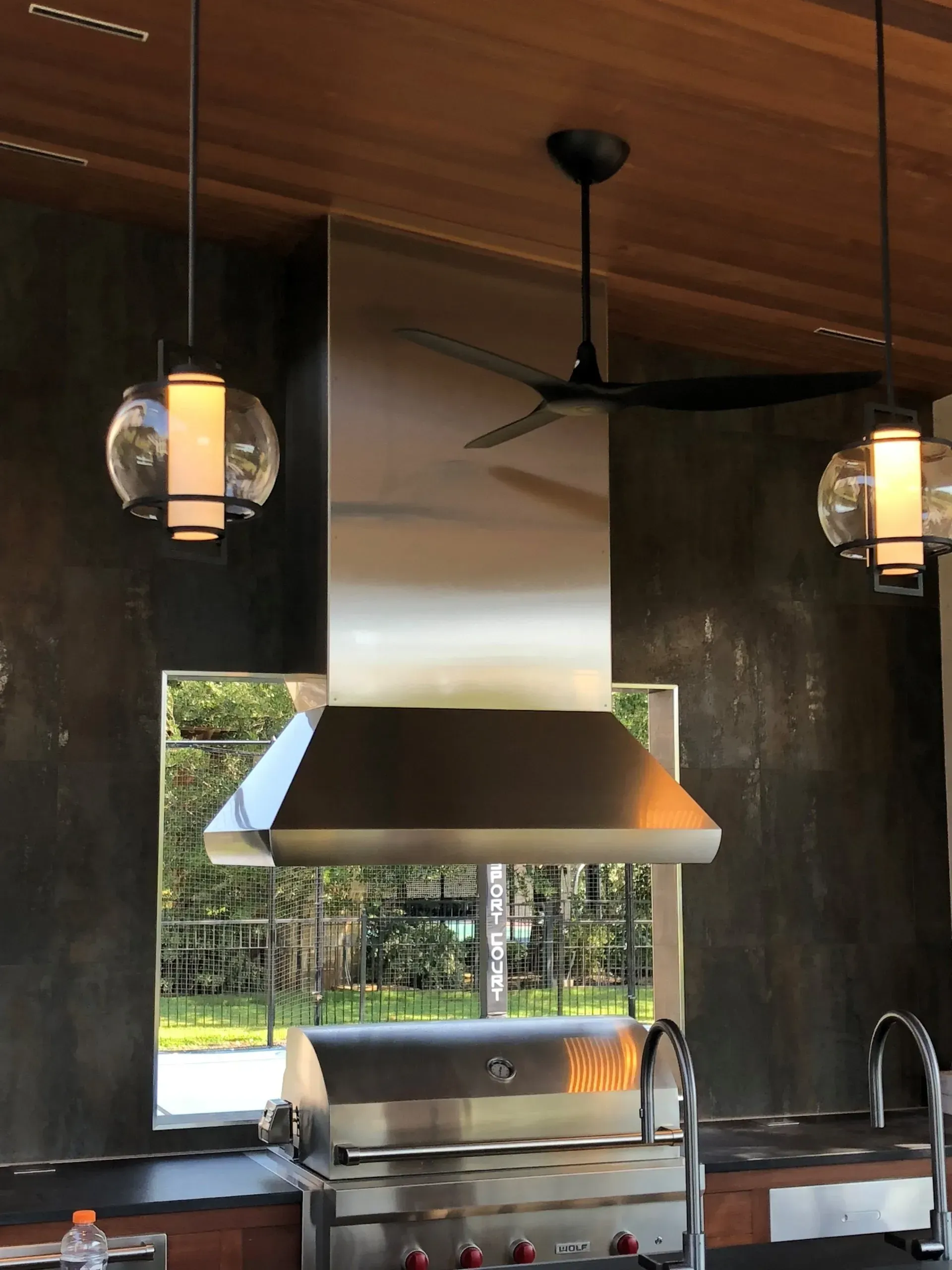 A kitchen with a grill and a ceiling fan