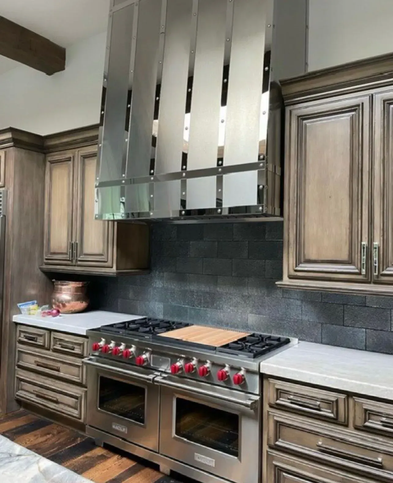 A kitchen with stainless steel appliances and wooden cabinets