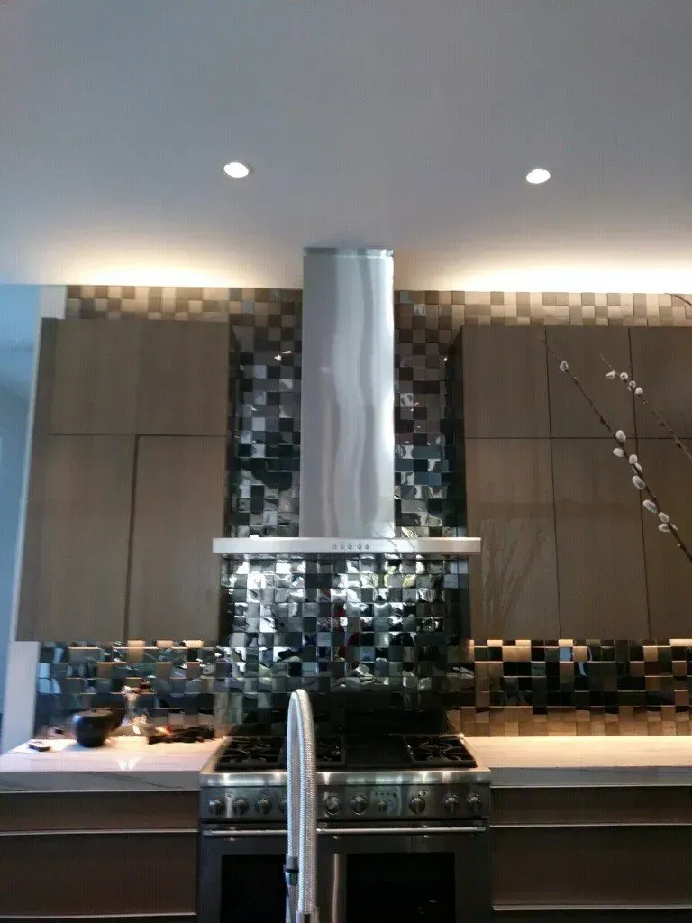 A kitchen with a stove top oven and a sink