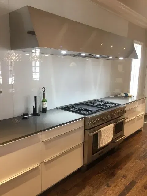 A kitchen with a stove top oven and a sink.
