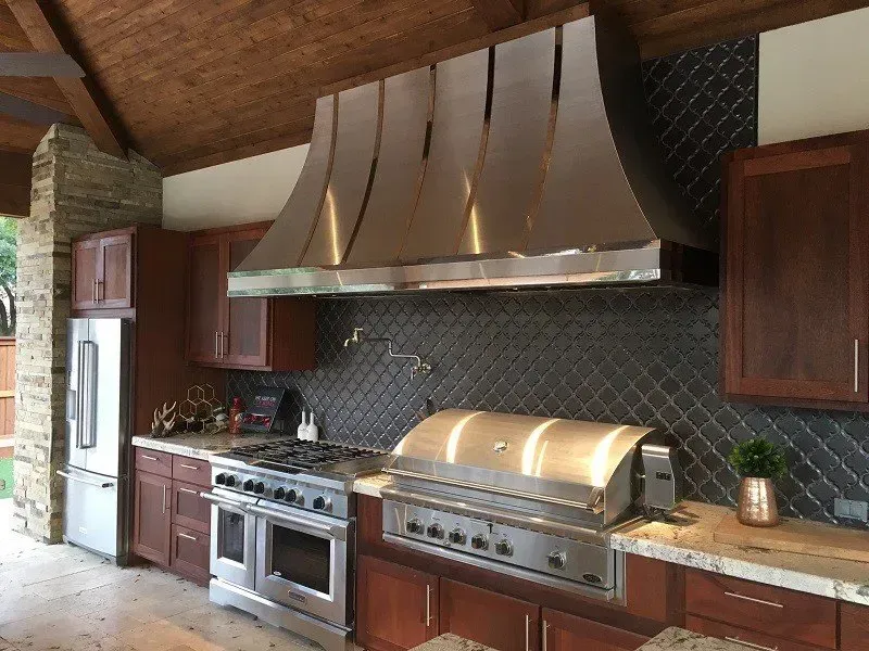 A kitchen with stainless steel appliances and wooden cabinets