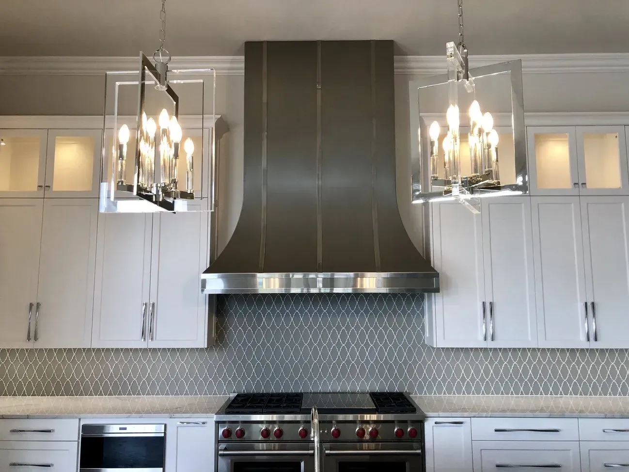 A kitchen with stainless steel appliances and white cabinets